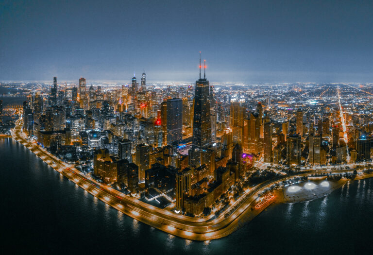 Chicago skyline and Lake Michigan shoreline at night, aerial | Matthew Hoyos