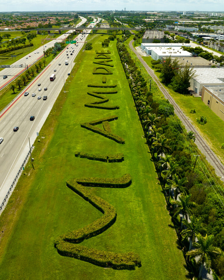 MIAMI-DADE hedge sign beside the Dolphin Expressway, aerial | Matthew Hoyos