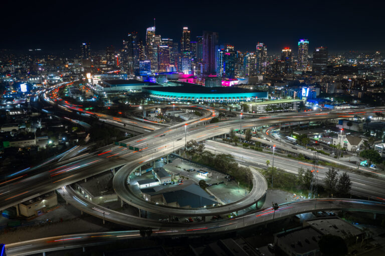 Downtown Los Angeles freeway interchange at night, aerial | Matthew Hoyos