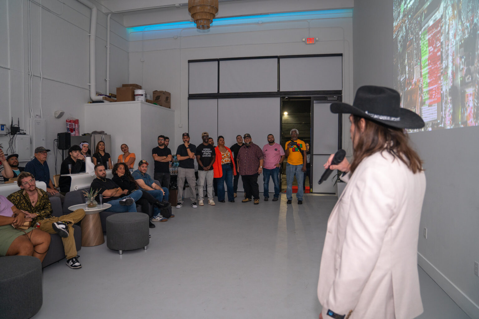 A speaker addressing the audience at the Talk of Miami unveiling