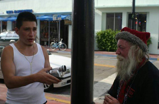 A young Matthew Hoyos filming a street interview in Miami Beach early in his career